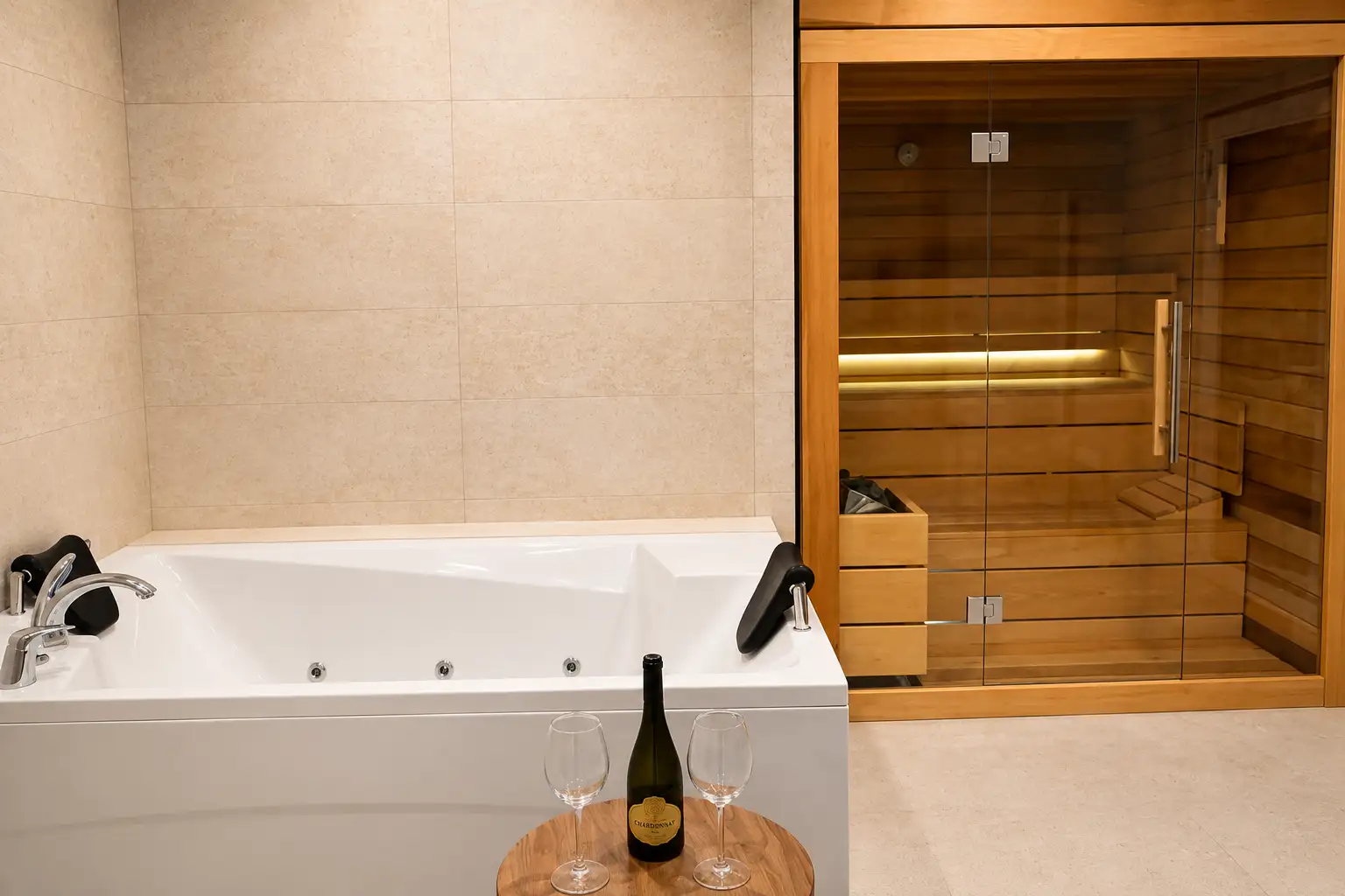 Wellness area with hot tub and timber-and-glass sauna cabin