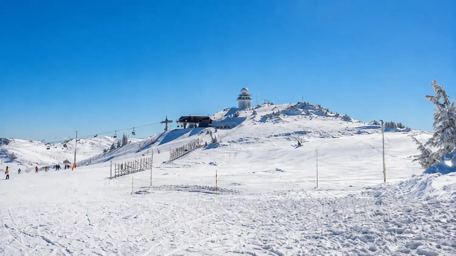 Snow-covered ski slopes and gondola on Jahorina mountain