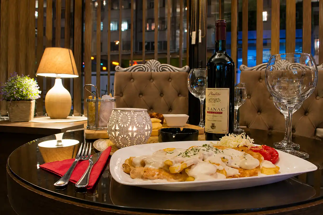 Plated main course with wine on a table in Restaurant Zlatna Žita