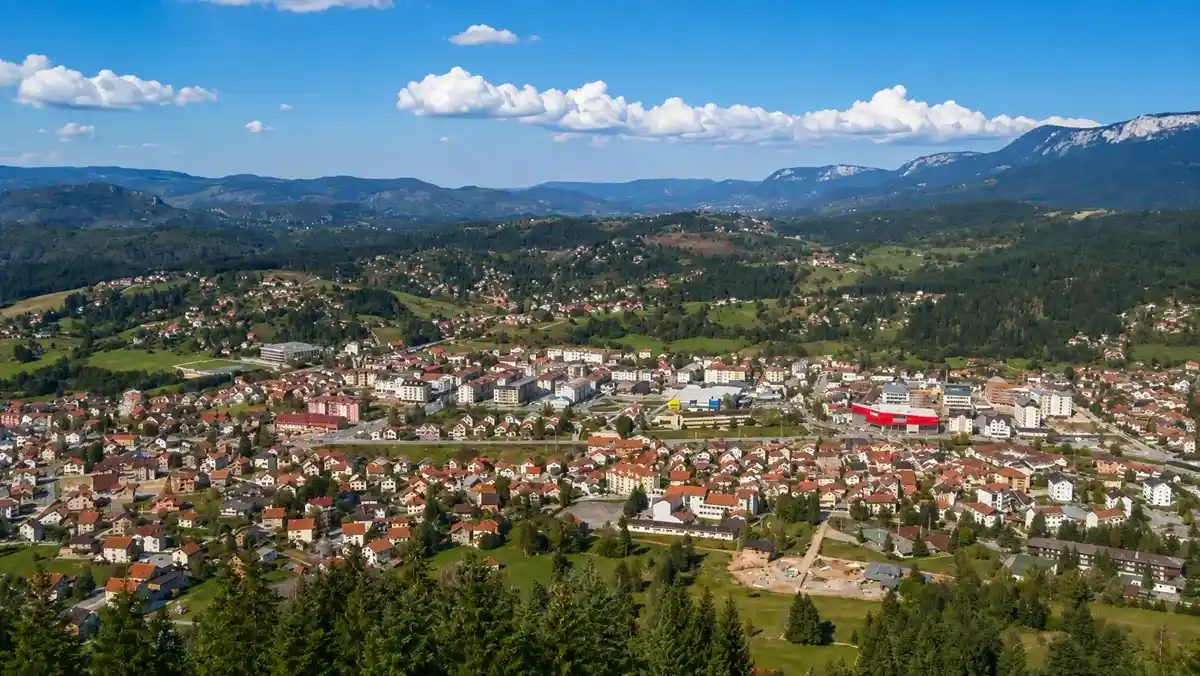 Aerial view of the town of Pale surrounded by green hills and mountains