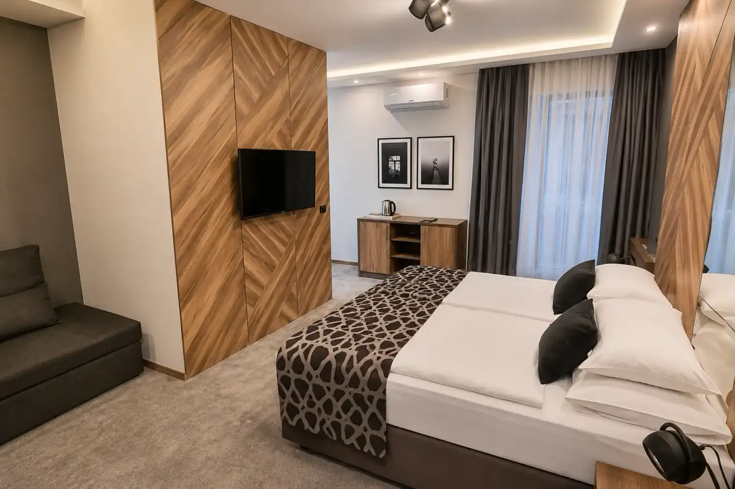 Deluxe double room with a queen bed, sofa bed and access to a private balcony